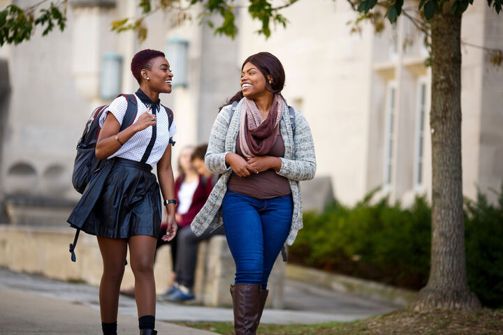 Two IU students walk on campus.